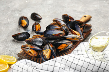 Wall Mural - Wooden board with raw mussels on grunge background