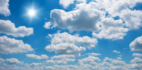 Wall Mural - blue sky with clouds and sun.