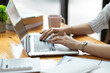 © bongkarn - Success businesswoman typing on laptop keyboard, working on laptop