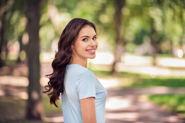 Turned photo of nice pretty positive young woman smile good mood vacation outside outdoors park street city