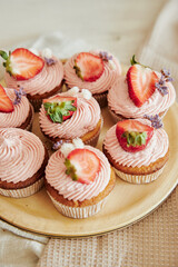 Wall Mural - Vertical shot of delicious strawberry cupcakes