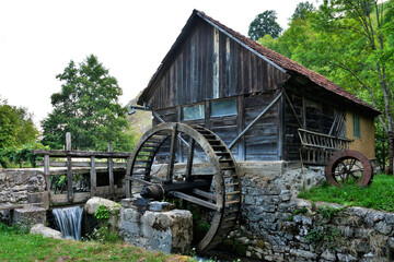 an old wooden mill on a stream