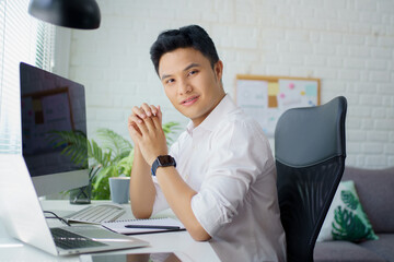 Poster - Young and successful. Happy bearded trader in formal wear with looking at camera and smiling while sitting in his modern office. Analyzing data.