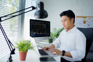 Poster - Handsome Asian man in work clothes is trading for investment, he do this deal on a stock exchange. People working in the office.