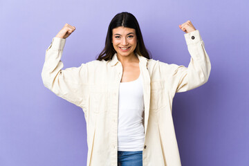 Wall Mural - Young brunette woman over isolated purple background doing strong gesture