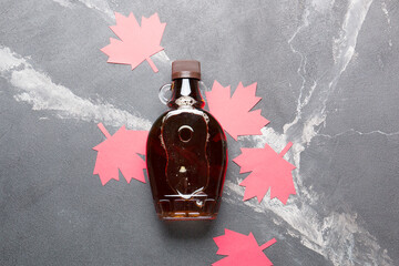 Wall Mural - Canadian maple syrup in a bottle on a dark background.