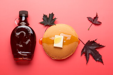 Wall Mural - Maple syrup on a red background. Maple Syrup Pancakes

