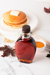Wall Mural - Beautiful maple syrup in a bottle. Maple leaves
