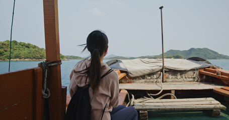 Wall Mural - Woman sit on the ship and move on sea