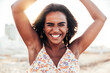 © Davide Angelini - Portrait of a young black woman having fun at beach party - Happy female enjoying sunset by the sea - Beauty, positive and happy lifestyle concept