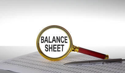 Aufkleber - Inscription BALANCE SHEET on magnifying glass with chart and pen