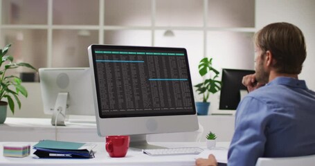 Poster - caucasian man sitting at desk coding data on laptop