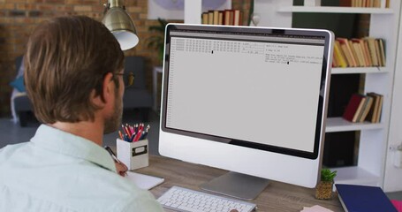 Poster - Caucasian man sitting at desk watching coding data processing on computer screen