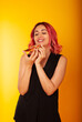 © Marina Chernivetskay - a girl of European nationality greedily looks at a piece of pizza wants to eat it on a yellow background with a place for the text