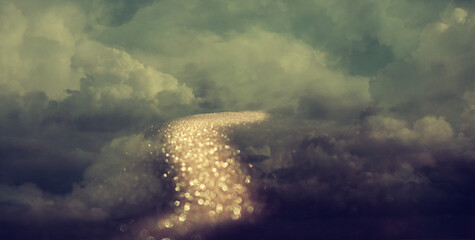 Abstract image of golden path in cloudy sky