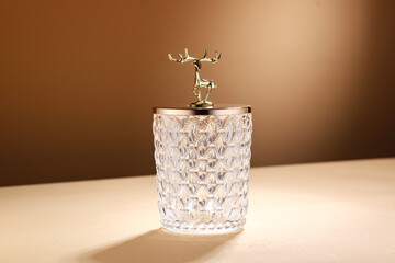 Empty Glass jar on beige background and light wall