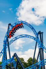 Ride Roller Coaster In Motion In Amusement Park