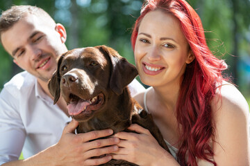 Wall Mural - Couple with a dog in the park