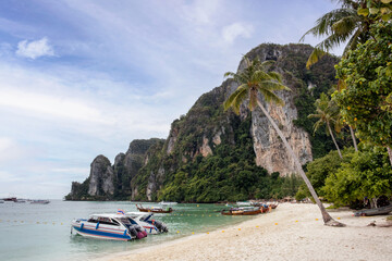 Wall Mural - Phi Phi islands with andaman tropical sea, limestone mountain and boat anchored on the beach