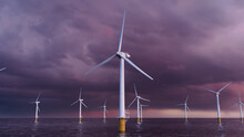 Wind Power. Offshore Wind Turbines At Dusk. Environmental Power Concept.