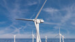 © RocknRoller Studios - Wind Power. Offshore Wind Turbines on a Hazy Morning. Environmental Energy Concept.