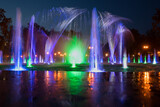 Fototapeta Tęcza - Beautiful colored fountains in the evening.