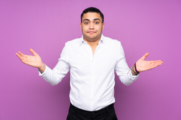 Wall Mural - Asian handsome man isolated on blue background having doubts while raising hands