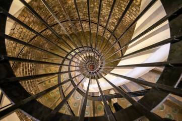 Wall Mural - Old spiral staircase in deep and long undergrounds caves for making champagne sparkling wine from chardonnay and pinor noir grapes in Reims, Champagne, France