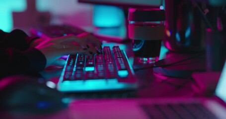 computer hands typing on keyboard programmer coding hacking data on internet cyber crime information hack by anonymous hacker using rgb gaming keyboard with blue backlight