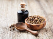 Propolis granules with tincture on wooden background
