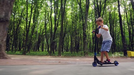 Poster - A boy rides a scooter in a city park