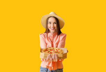 Poster - Beautiful young woman with tasty pizza on color background