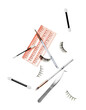 False eyelashes with makeup accessories on white background