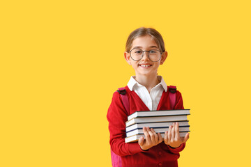 Wall Mural - Cute little school girl with books on color background