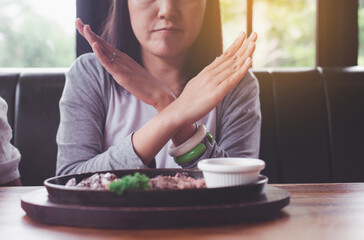 Hands woman refusing beef steak in restaurant,No meal,Vegetarian and vegan concept