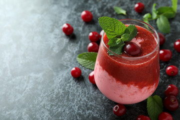 Wall Mural - Glass of cherry smoothie and ingredients on black smokey table