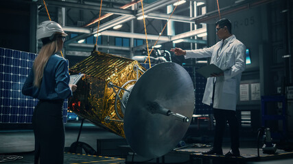 Wall Mural - Engineer and Technician Working on Satellite Construction. Aerospace Agency: Diverse Team of Scientists Using Technological Equipment and Laptop Computer to Develop Spacecraft for Space Exploration.