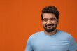 © IndiaPix - Portrait of a man smiling against plain backdrop.