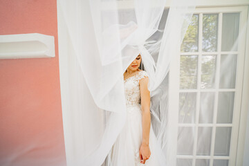 Wall Mural - portrait of a beautiful and gentle bride with a long veil. femininity and beauty