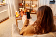 © Syda Productions - halloween, holidays and leisure concept - young woman using smartphone at home