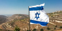 Israeli Flag On The Background Of Judea And Samaria. Sunny Day Overlooking Rare Settlements In The Desert