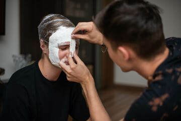 The process of making a plaster mask at home. creating masks based on a plaster cast. Gypsum mold. Cast of the face. Sculpting. The workflow of the artist.