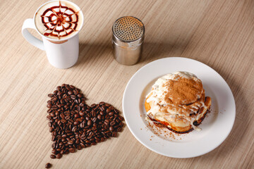 Wall Mural - Closeup shot of a delicious croissant with a cup of coffee in a cafe