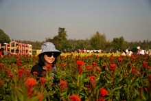 Woman Wearing Red Flowers On Field