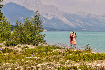 Wall Mural - Young mother and teenager son hiking along the shores of Abraham Lake in the Canadian Rocky Mountains