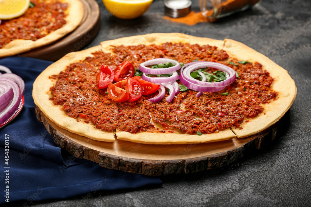 Board with delicious Turkish pizza on dark background