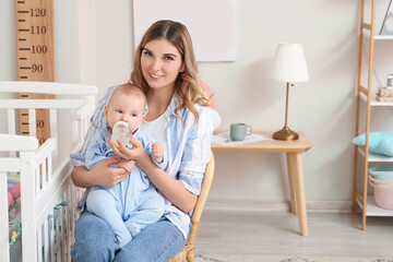 Poster - Young mother giving water to her cute baby at home