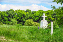 White Christian Cross Field Near The Forest