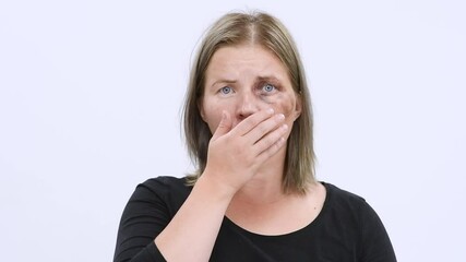 Wall Mural - Shoked beaten up woman looking at camera and covered her mouth with her hands