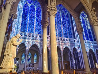 Wall Mural - Beautiful interior of the basilica of Pontmain, northern France. Blue Stained glass windows

